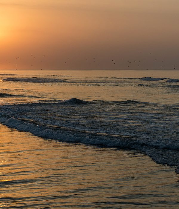 Amazing Sunset red sky waves at the beach in Salalah Oman